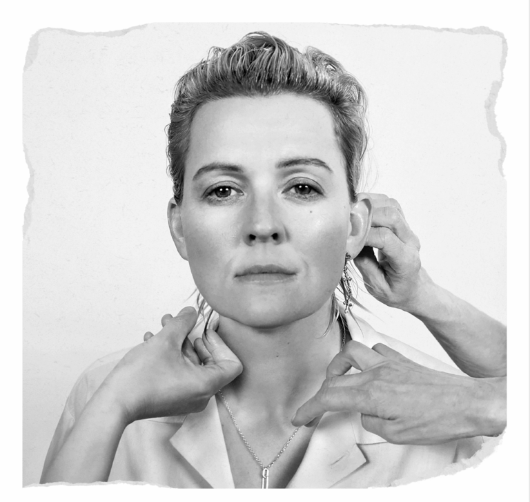 Album cover Image of 'Returning to Myself' image of Brandi Carlile with multiple hands adjusting her hair and clothing